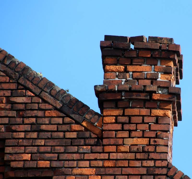 Signs Your Dearborn Home Needs a Chimney Inspection Damaged chimney on an Dearborn home showing cracks and missing mortar